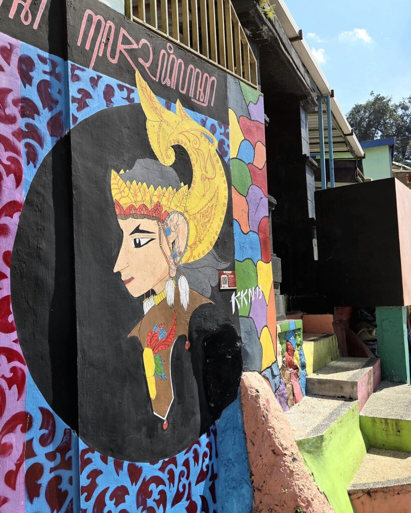 Mural z postacią wayang w złotej koronie na ścianie domu